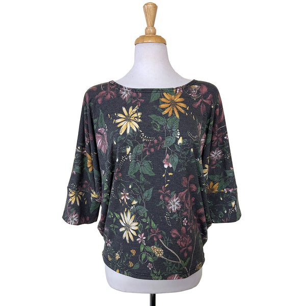 Batwing Top with 3/4 sleeves in a lovely muted floral print in pink, yellow and green on a classic charcoal background. An elegant print on a flattering cut and a cozy feel.