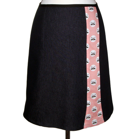 Dark knee length denim skirt with stripe of fun cotton printed with polka dots and raccoon faces on a pink background